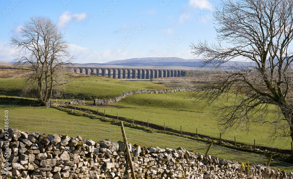 Fototapeta premium The Ribblehead Viaduct bridge crossing through the Yorkshire Dales, England.