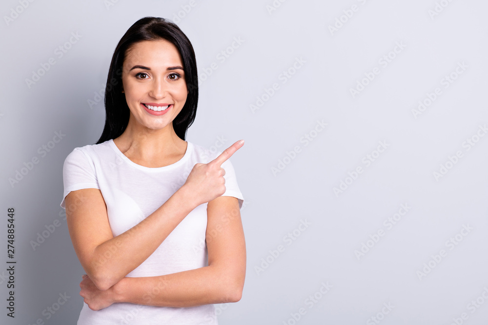 Portrait of her she nice-looking charming attractive lovely shine positive cheerful cheery girl pointing aside ad copy space isolated over light gray pastel background Portrait of her she nice-looking charming attractive lovely shine positive cheerful cheery girl pointing aside ad copy space isolated over light gray pastel background