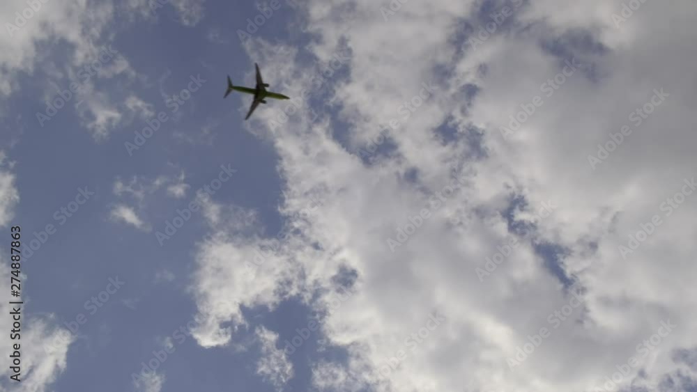 plane flies on background blue sky with floating clouds. plane flies on background blue sky with floating clouds.