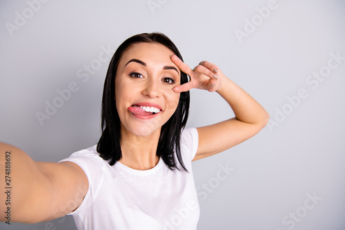 Self-portrait of her she nice-looking attractive lovely charming cheerful cheery crazy funky girl having fun showing v-sign party holiday mood life lifestyle isolated over light gray pastel background