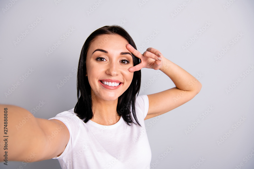 Self-portrait of her she nice-looking attractive lovely charming cheerful cheery glad optimistic girl having fun showing v-sign party time isolated over light gray pastel background Self-portrait of her she nice-looking attractive lovely charming cheerful cheery glad optimistic girl having fun showing v-sign party time isolated over light gray pastel background
