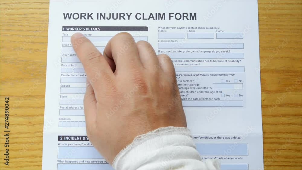 man with a wrap hand reading a work injury claim form