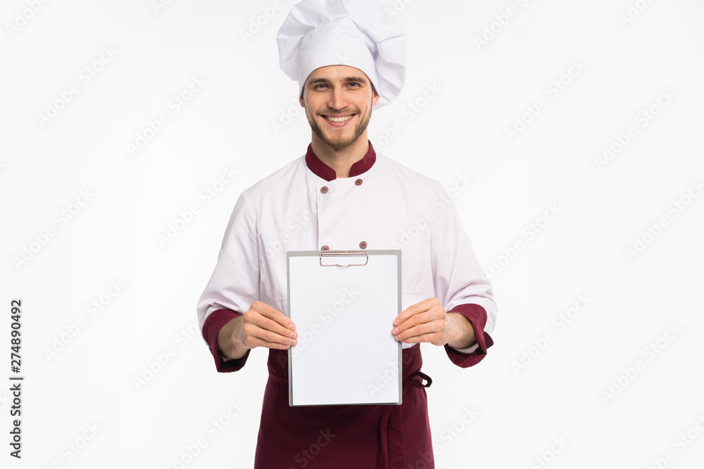 Portrait of a cheerful male chef cook in uniform holding blank board isolated on a white background. Portrait of a cheerful male chef cook in uniform holding blank board isolated on a white background.
