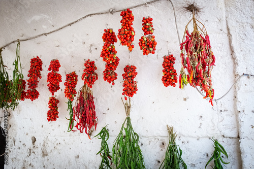 Typical old town house with peppers and tomato hung out to dry. Spinazzola, Apulia region, Italy