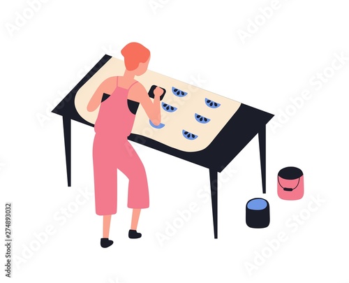 Funny girl printing pattern on fabric using woodblocks and paint isolated on white background