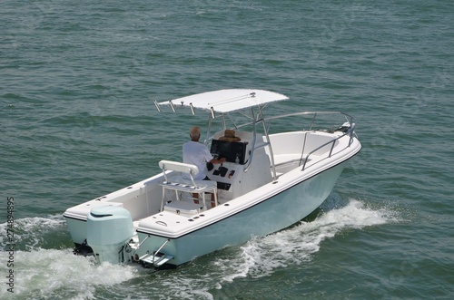Small light blue and white sport fishing boat on the Florida Intra-Coastal Waterway off Miami Beach