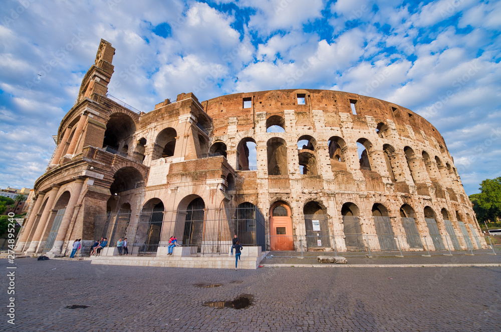 ROME, ITALY - JUNE 2014: Tourists visit Colosseum. The city attracts 15 million people annually