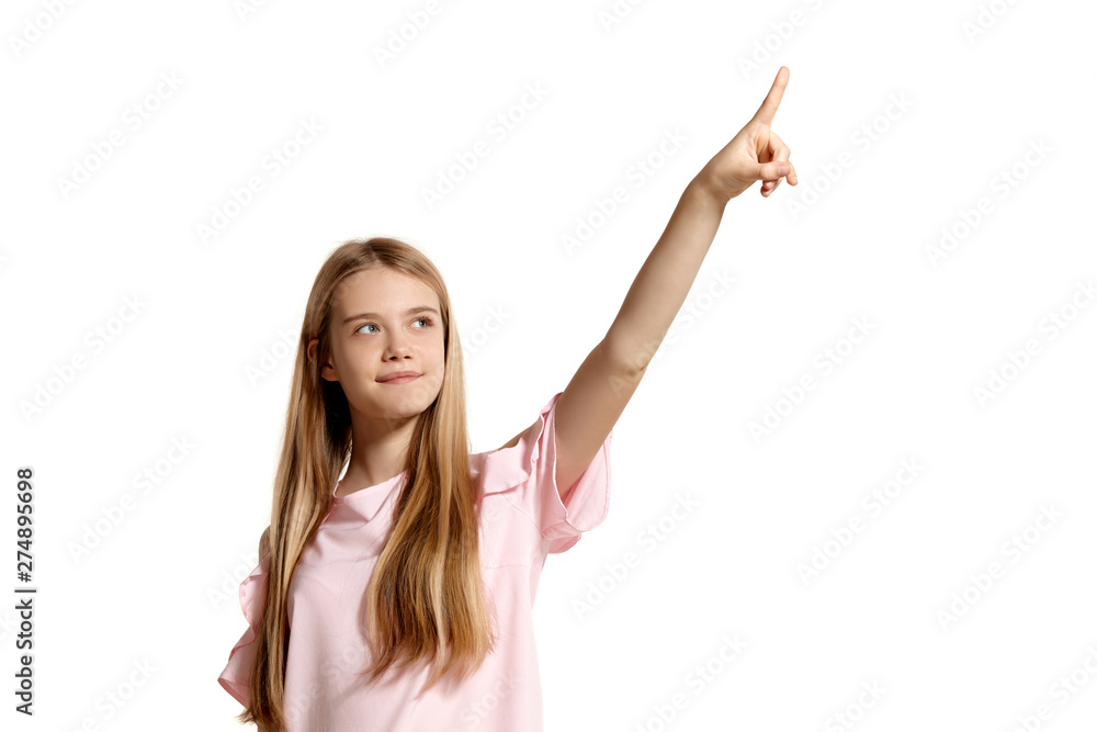Studio portrait of a beautiful girl blonde teenager in a pink t-shirt posing isolated on white background. Studio portrait of a beautiful girl blonde teenager in a pink t-shirt posing isolated on white background.