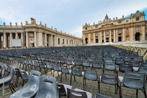 ROME, ITALY - JUNE 2014: Tourists visit St Peter Square in Vatican. The city attracts 15 million people annually photo