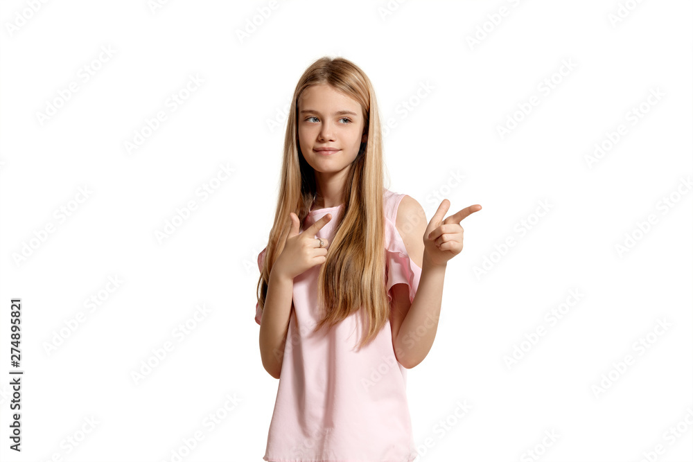 Studio portrait of a beautiful girl blonde teenager in a pink t-shirt posing isolated on white background. Studio portrait of a beautiful girl blonde teenager in a pink t-shirt posing isolated on white background.
