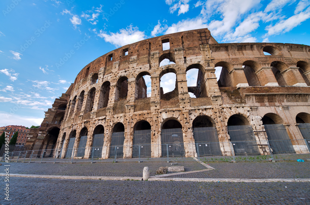 ROME, ITALY - JUNE 2014: Tourists visit Colosseum. The city attracts 15 million people annually