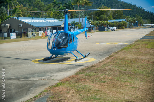 AIRLIE BEACH, AUSTRALIA - AUGUST 25, 2018: Helicopter in Whitsunday Airport ready for islands excursion. The city is the gateway to the Whitsunday Islands