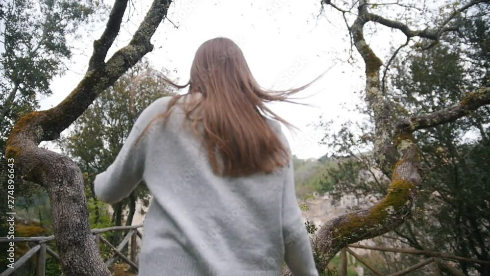 Young woman running to a observation deck and call a man with her Young woman running to a observation deck and call a man with her