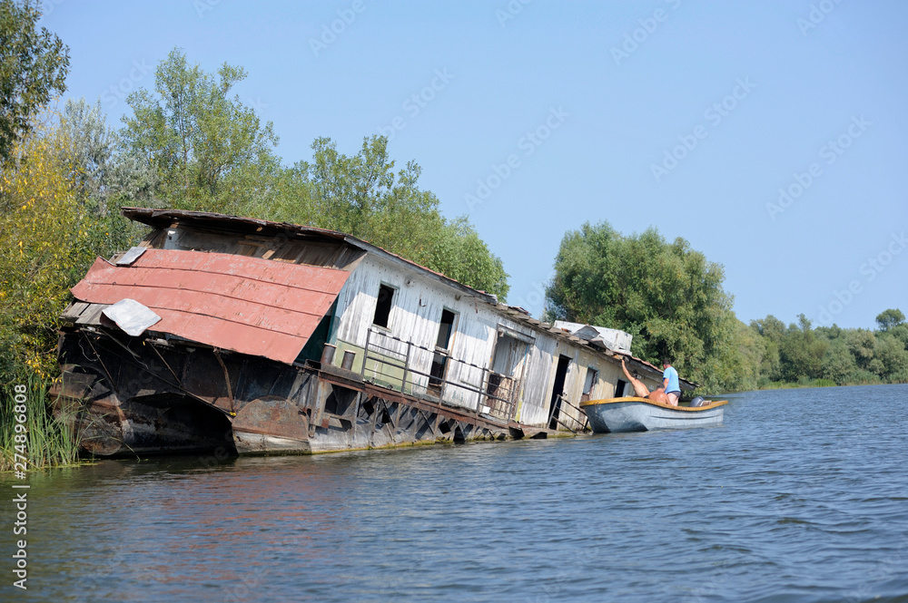 View of a canal-street of Vilkovo village (called Ukrainian Venice) with a boat abondoned