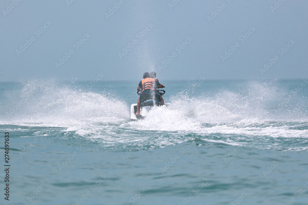 Jet ski at speed in a spray of water