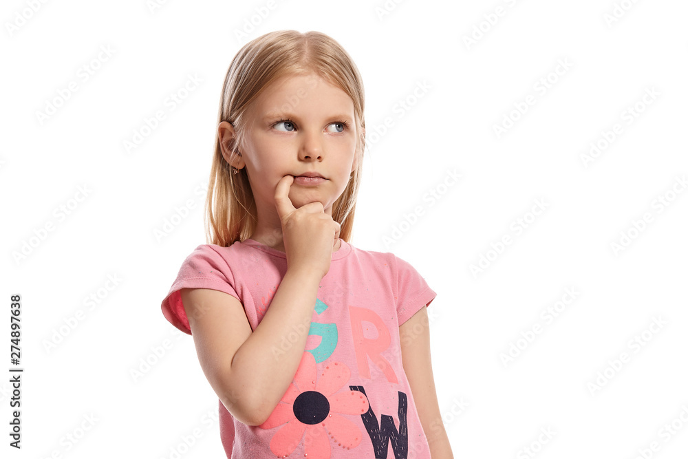 Close-up portrait of a nice blonde little kid in a pink t-shirt posing isolated on white background. Close-up portrait of a nice blonde little kid in a pink t-shirt posing isolated on white background.
