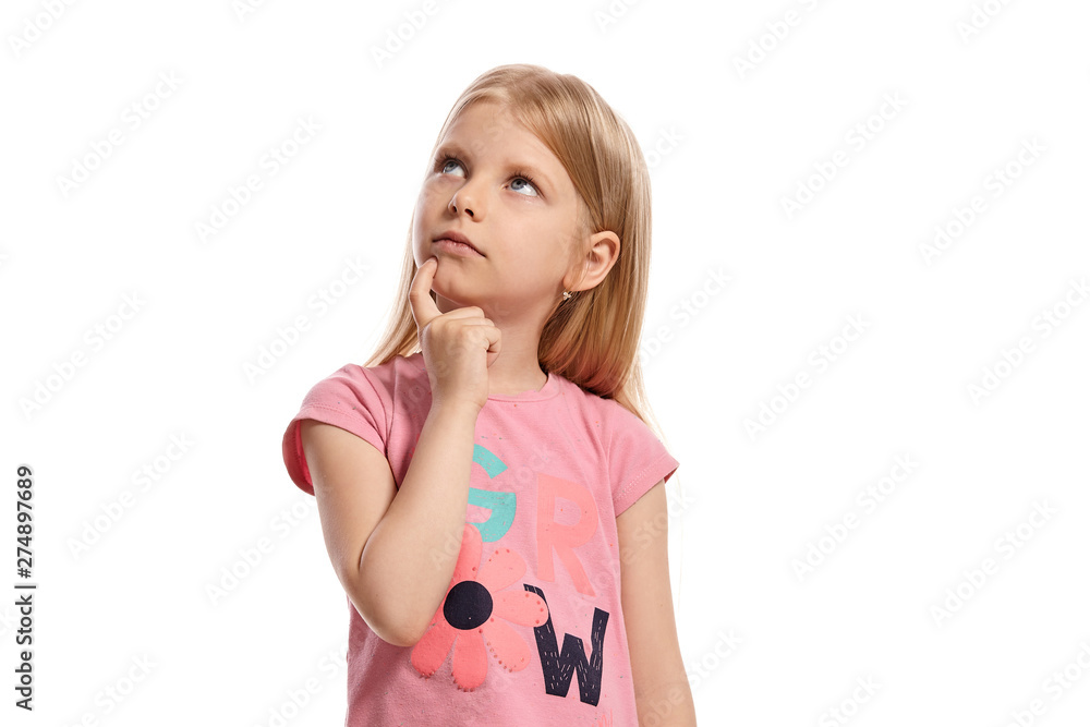 Close-up portrait of a nice blonde little kid in a pink t-shirt posing isolated on white background. Close-up portrait of a nice blonde little kid in a pink t-shirt posing isolated on white background.