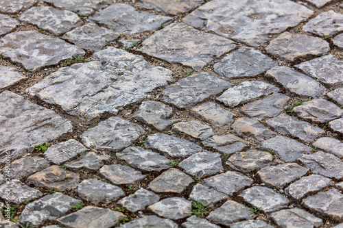 Old cobbles on the road as abstract background