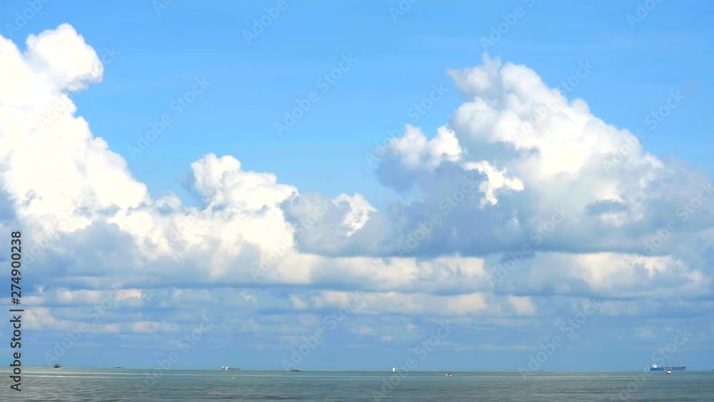 pure blue sky white cloud moving from left to right over sea pure blue sky white cloud moving from left to right over sea