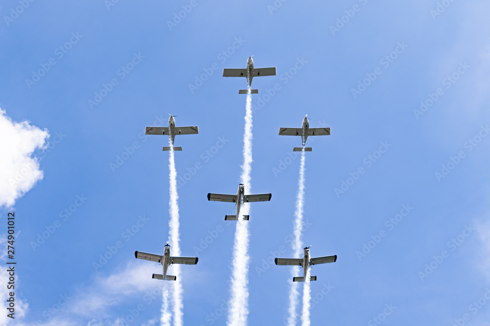 Airplanes on airshow. Aerobatic team performs flight at air show in Krakow, Poland.