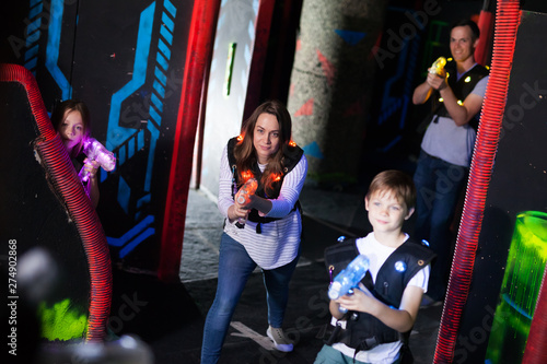 Kids with parents during lasertag game © JackF