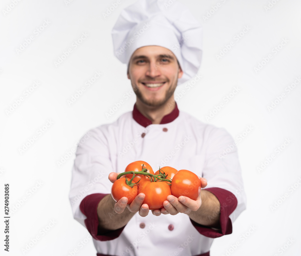 Food service, organic food, healthy diet, cooking and professional culinary concept - chef in white uniform holds vegetables. Food service, organic food, healthy diet, cooking and professional culinary concept - chef in white uniform holds vegetables.