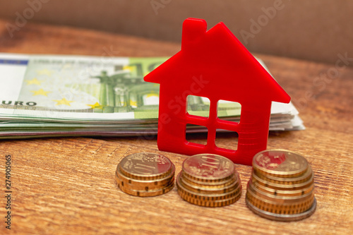 Home house on the staked coins background euro pile pack real estate concept expenses property buying mockup copy space close up background selective focus