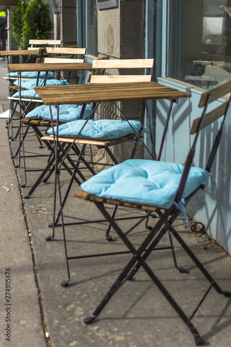 Summer terrace cafe. Empty tables and chairs. Garden furniture. Furniture cushions. Empty seats in the restaurant on the street. Place for morning coffee. Breakfast al fresco. Lunch time.