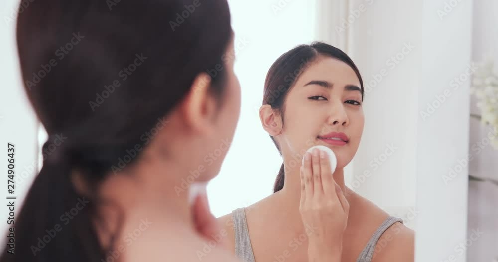 Asian beautiful woman cleaning her makeup at home. Beauty, makeup, health care concept. Asian beautiful woman cleaning her makeup at home. Beauty, makeup, health care concept.