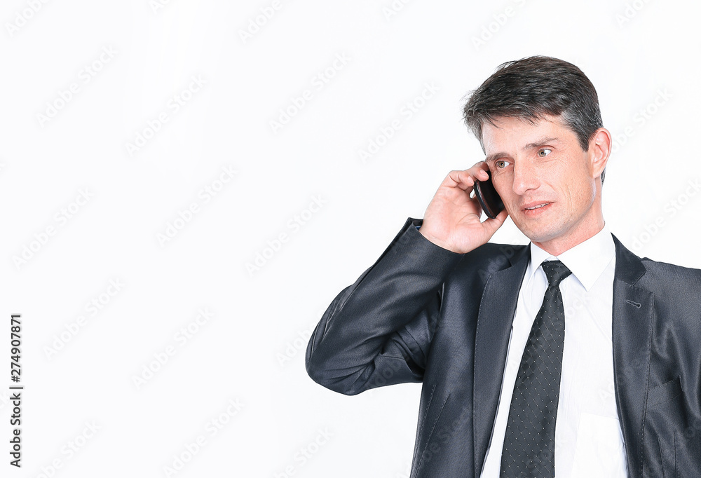 confident businessman talking on the phone.isolated on white confident businessman talking on the phone.isolated on white