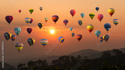 Hot air balloon above high mountain at sunset..A.