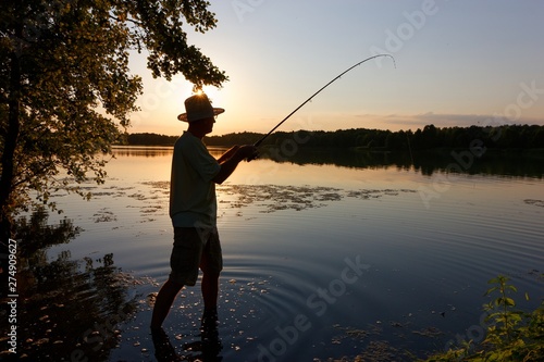 Silhouette of angler during sunset