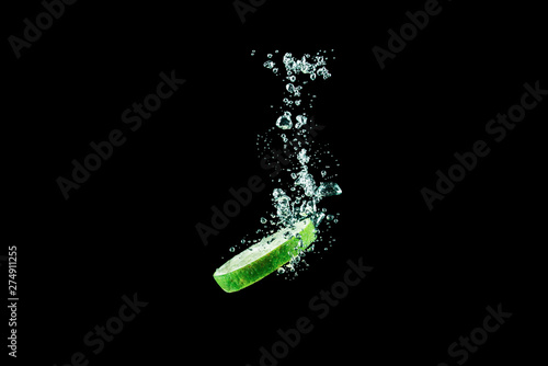 lime under water with splashes on a black background