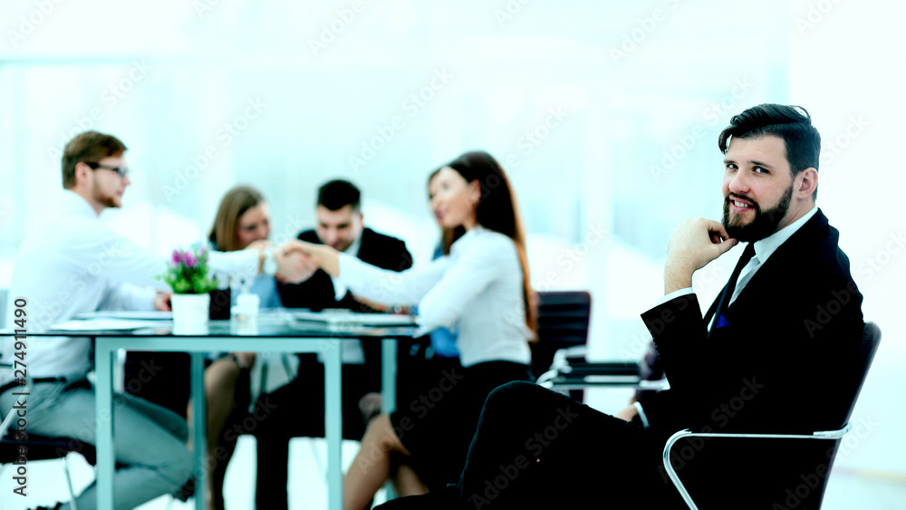 successful businessman on the background of his business team successful businessman on the background of his business team
