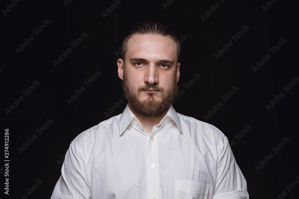 Close up portrait of young caucasian man isolated on black studio background. Photoshot of real emotions of male model. Mourning, mental suffering. Facial expression, human nature and emotions concept Close up portrait of young caucasian man isolated on black studio background. Photoshot of real emotions of male model. Mourning, mental suffering. Facial expression, human nature and emotions concept