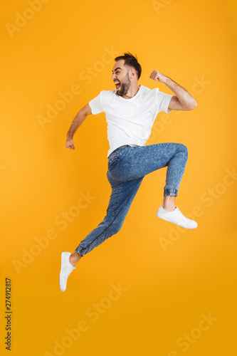 Full length photo of happy caucasian man having beard smiling and running