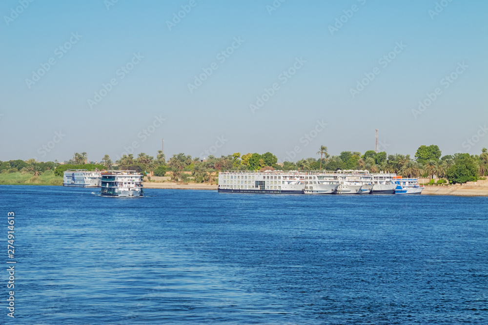 Nile cruise ships leaving the quay in the vicinity of Luxor