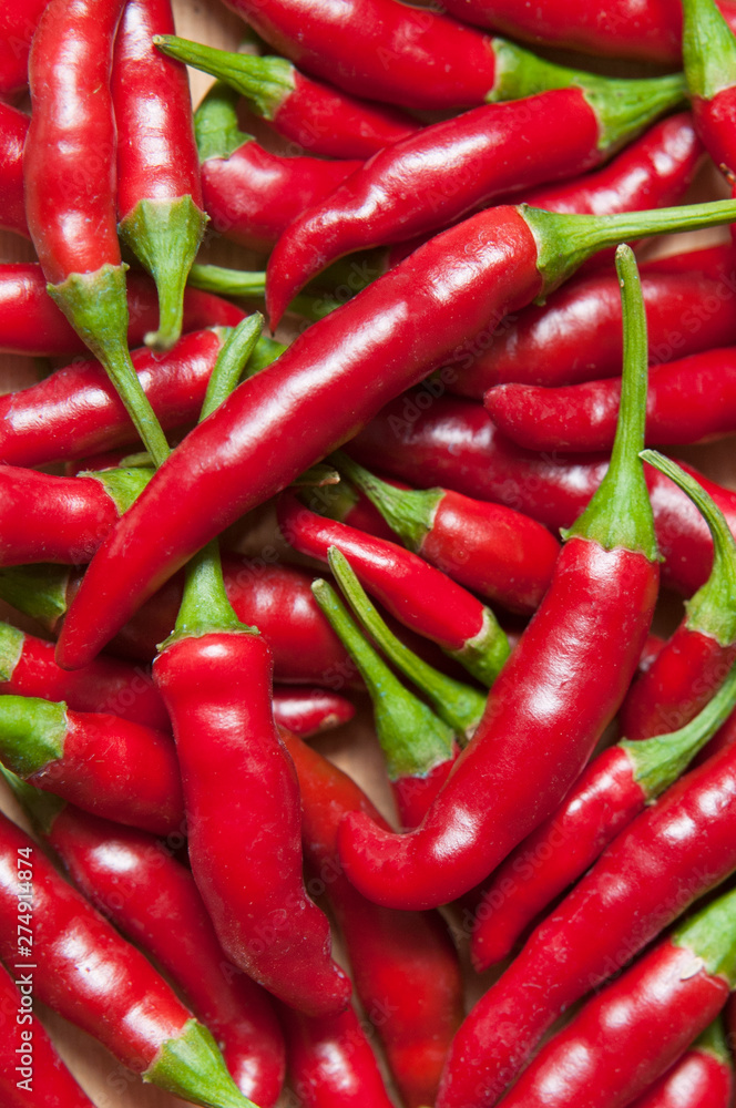 Some ripe fresh red chili peppers top view, vertical shot