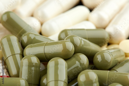 Close-up photo of many green and white capsules