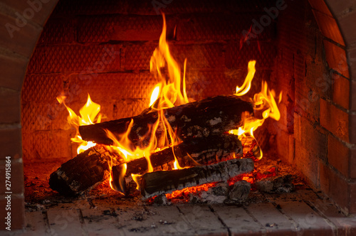 Fireplace burning. Warm cozy burning fire in a brick fireplace