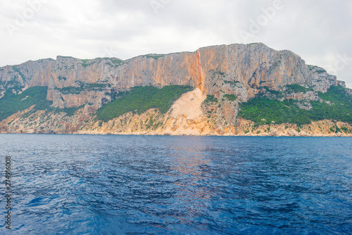 Rocky coast of the island of Sardinia in the Mediterranean Sea viewed from a boat photo