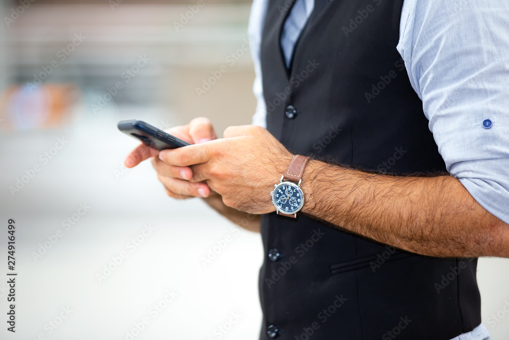 Portrait of smiling businessman with smartphone