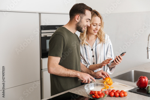 Loving couple cooking at the kitchen at home have a breakfast.