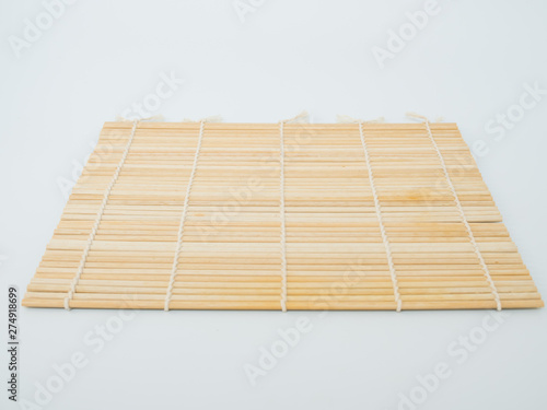 chopsticks on bamboo mat