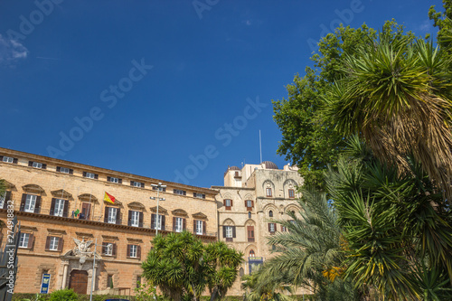 Popular tourist royal palace of Palermo Sicily  facade of historical Norman palace and beautiful green trees and palms