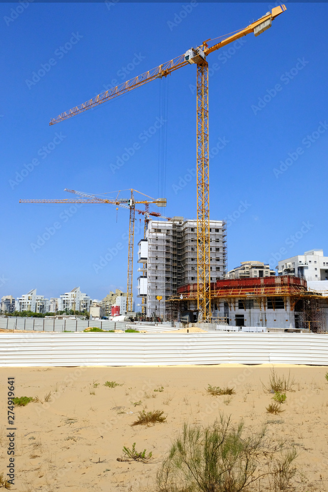 Building yard of Housing construction of houses in a new area of the city Holon in Israel Building yard of Housing construction of houses in a new area of the city Holon in Israel