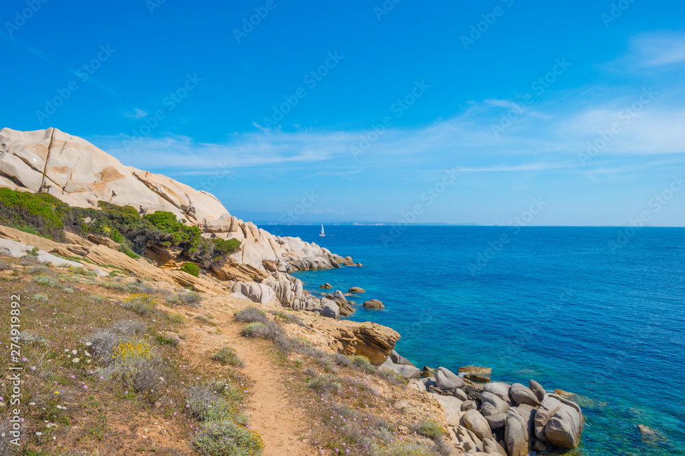 Rocky coast of the island of Sardinia in the Mediterranean Sea in sunlight in spring