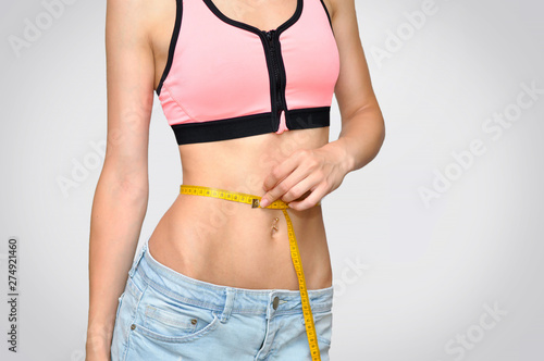 Beautiful sports belly WITH MEASURING AROUND WOMEN'S WAIST WHICH SHOWS 62 CENTIMETERS.