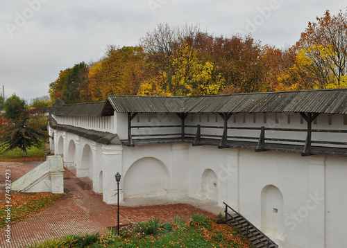 An old wooden fortress with high walls and a water ditch photo