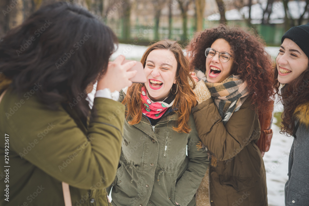 group of girlfriends having fun in winter day group of girlfriends having fun in winter day